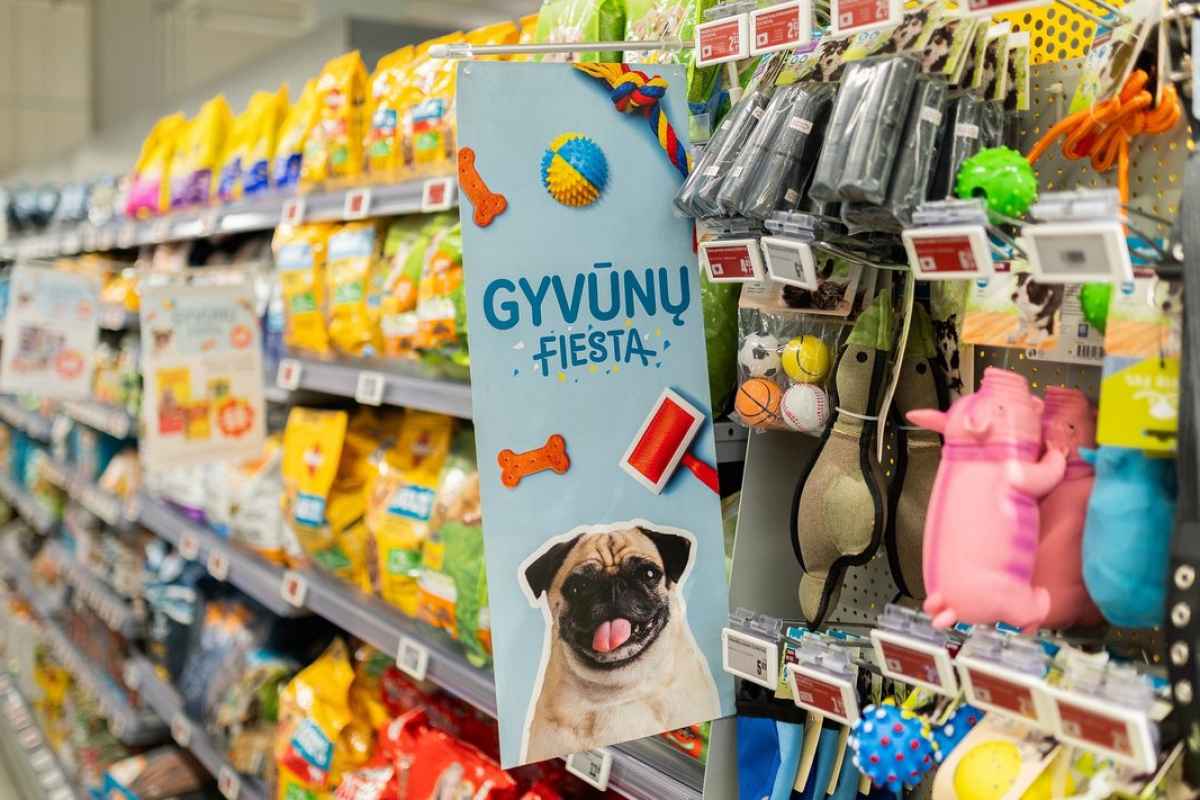 Prekių lentyna su įvairiais gyvūnų maisto pakeliais ir žaislais parduotuvėje.